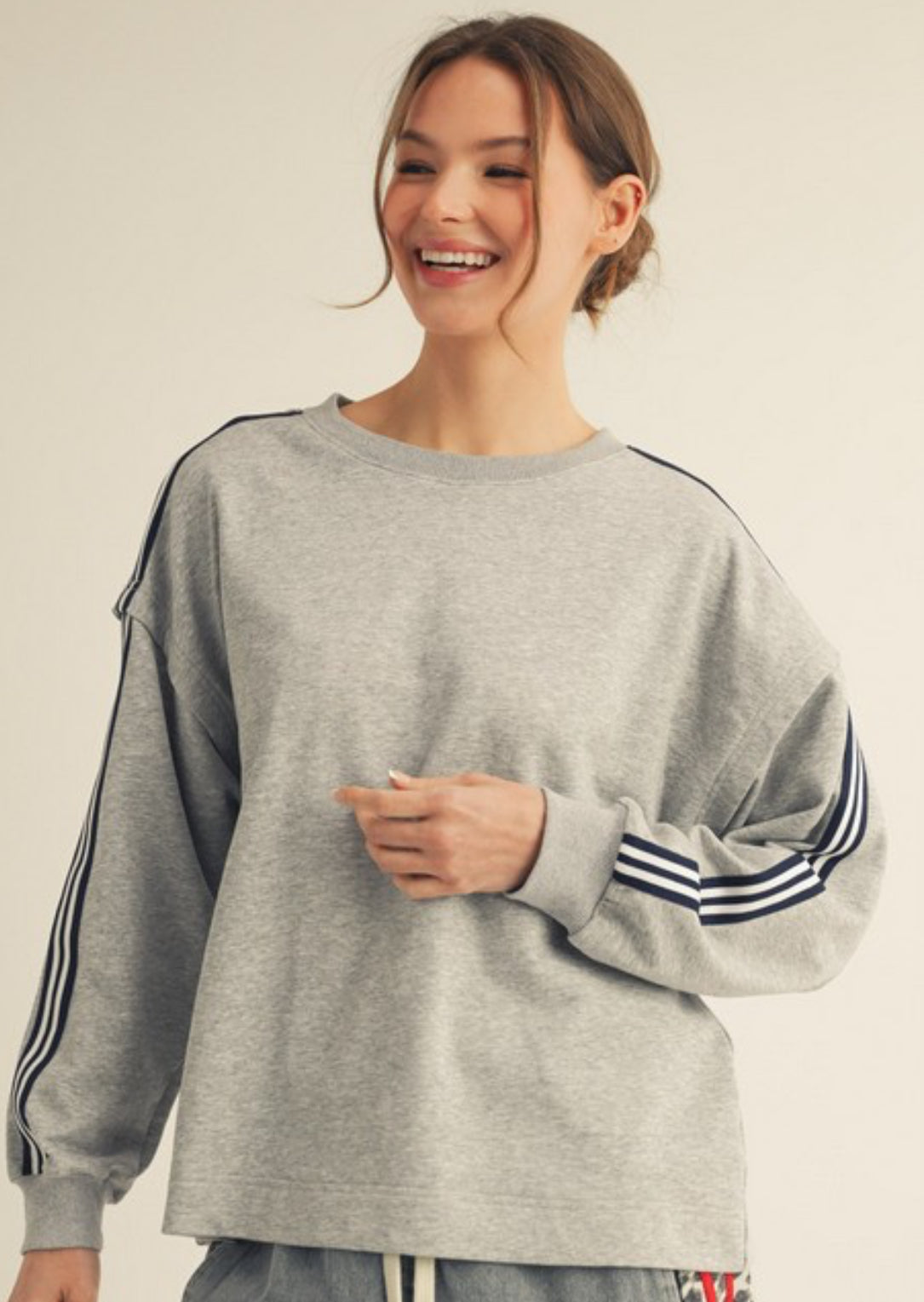 Grey sweatshirt with navy sleeve stripes