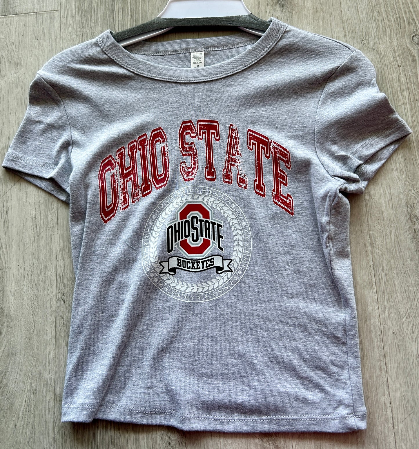 In stock baby tee with crest
