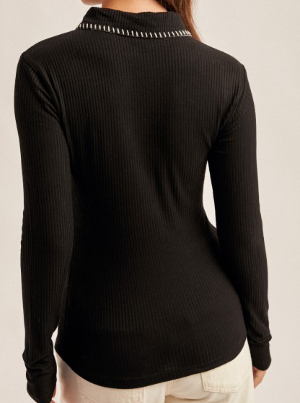 Black collared top with white stitching