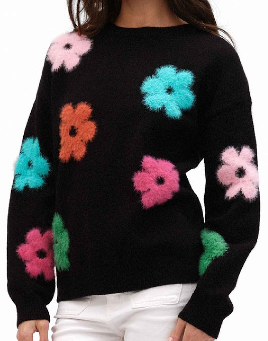 Black soft knit sweater with multicolored fuzzy daisies