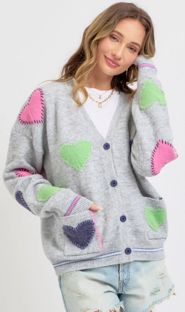 Grey sweater knit cardigan with multi heart patches