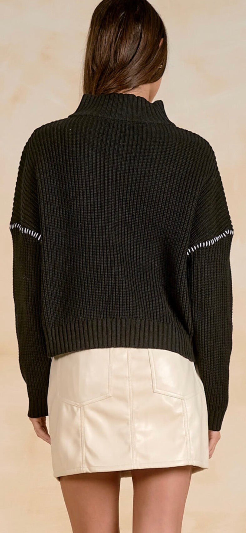 Black soft knit quarter zip sweater with white stitching