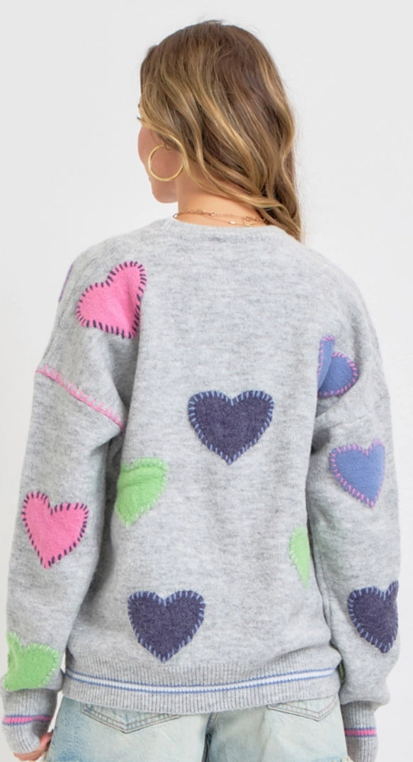 Grey sweater knit cardigan with multi heart patches