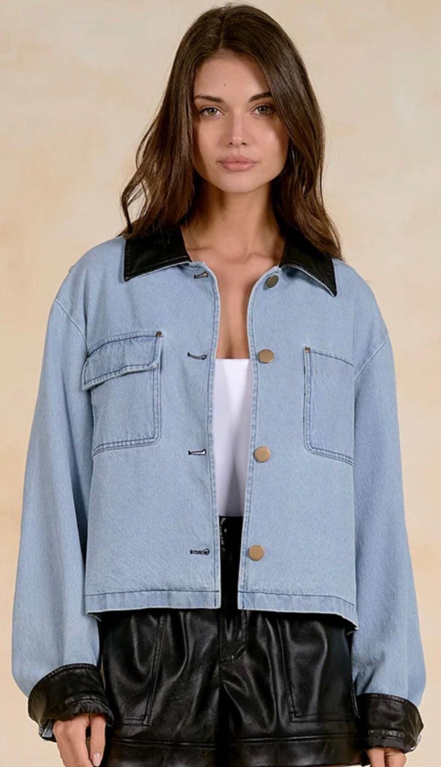 Denim jacket with black leather cuffs and collar