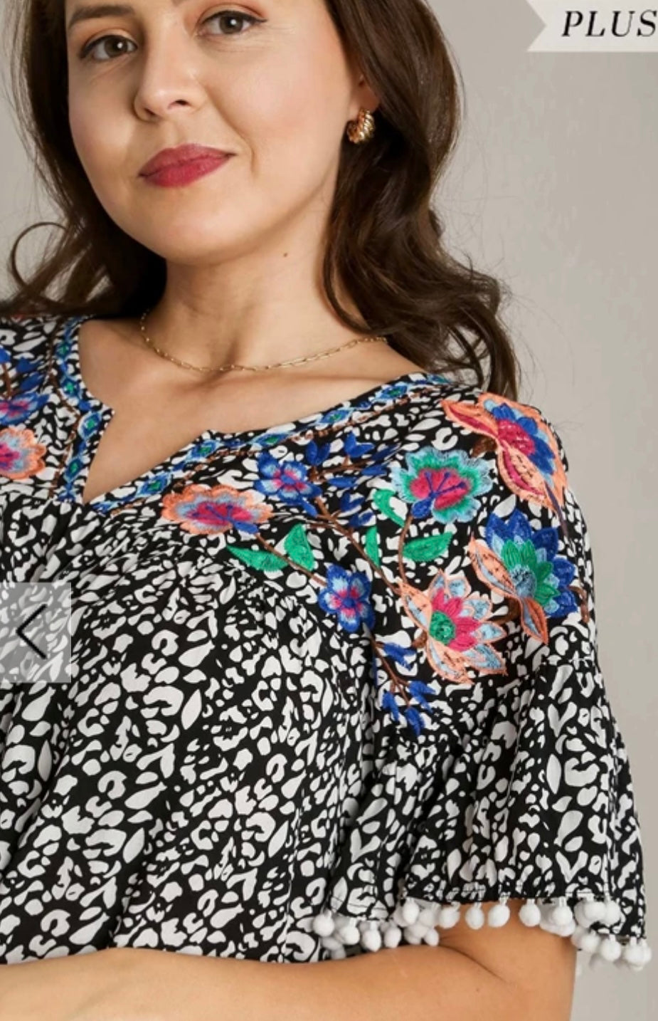 Plus size print top with floral and poms detail