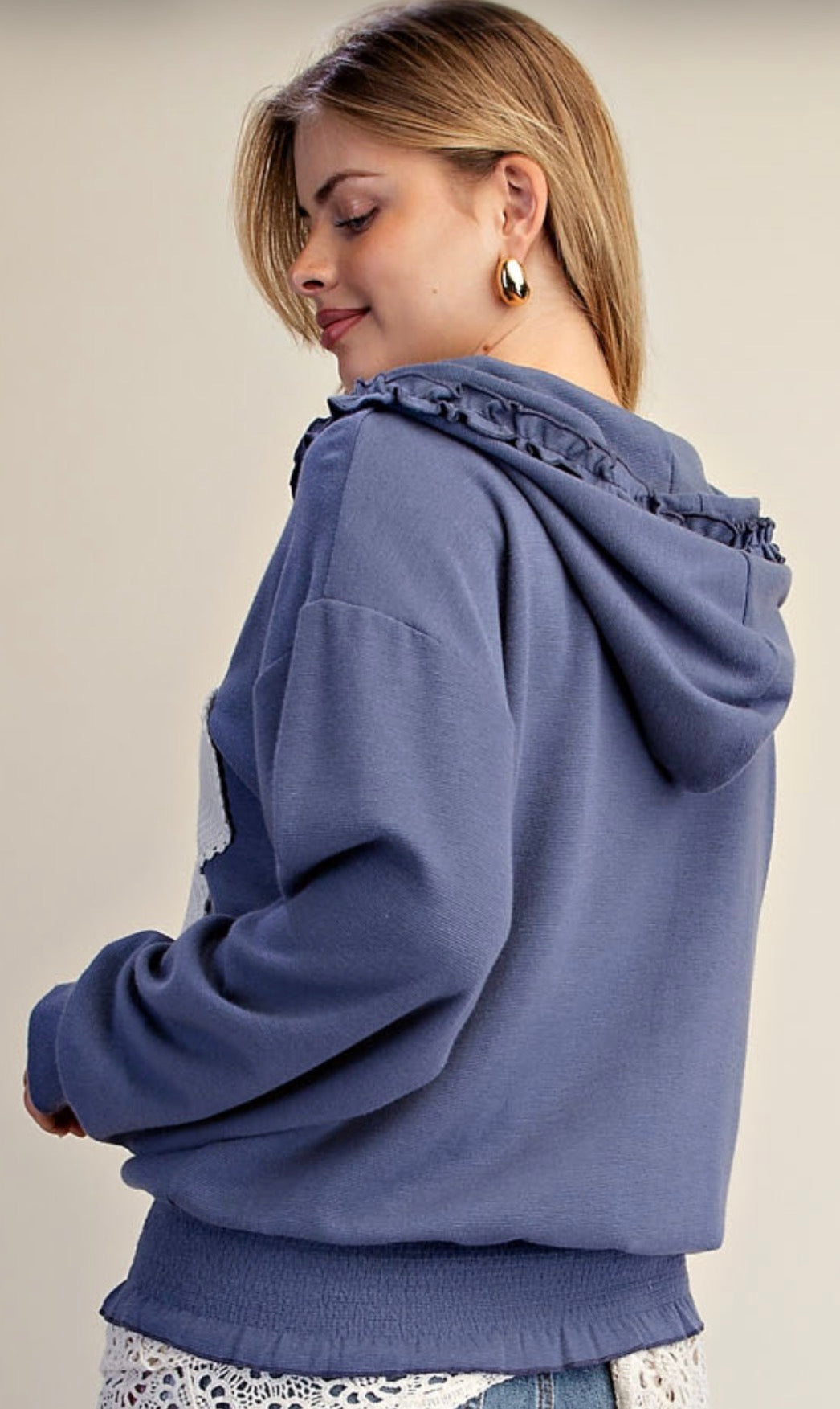 Blue zip hoodie with white flower patch and ruffle detail