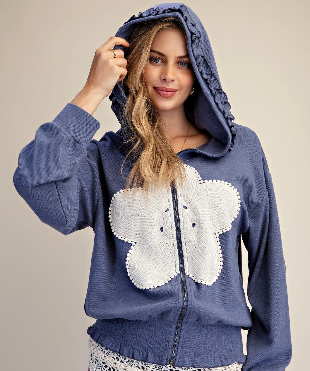 Blue zip hoodie with white flower patch and ruffle detail