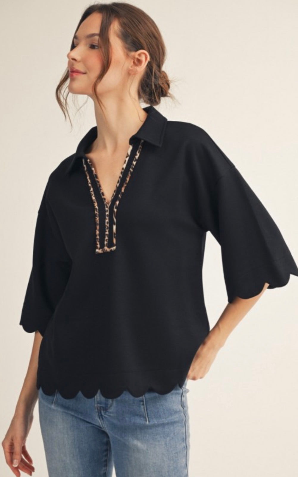 Black soft knit top with leopard trim and scallop bottom and elbow sleeves