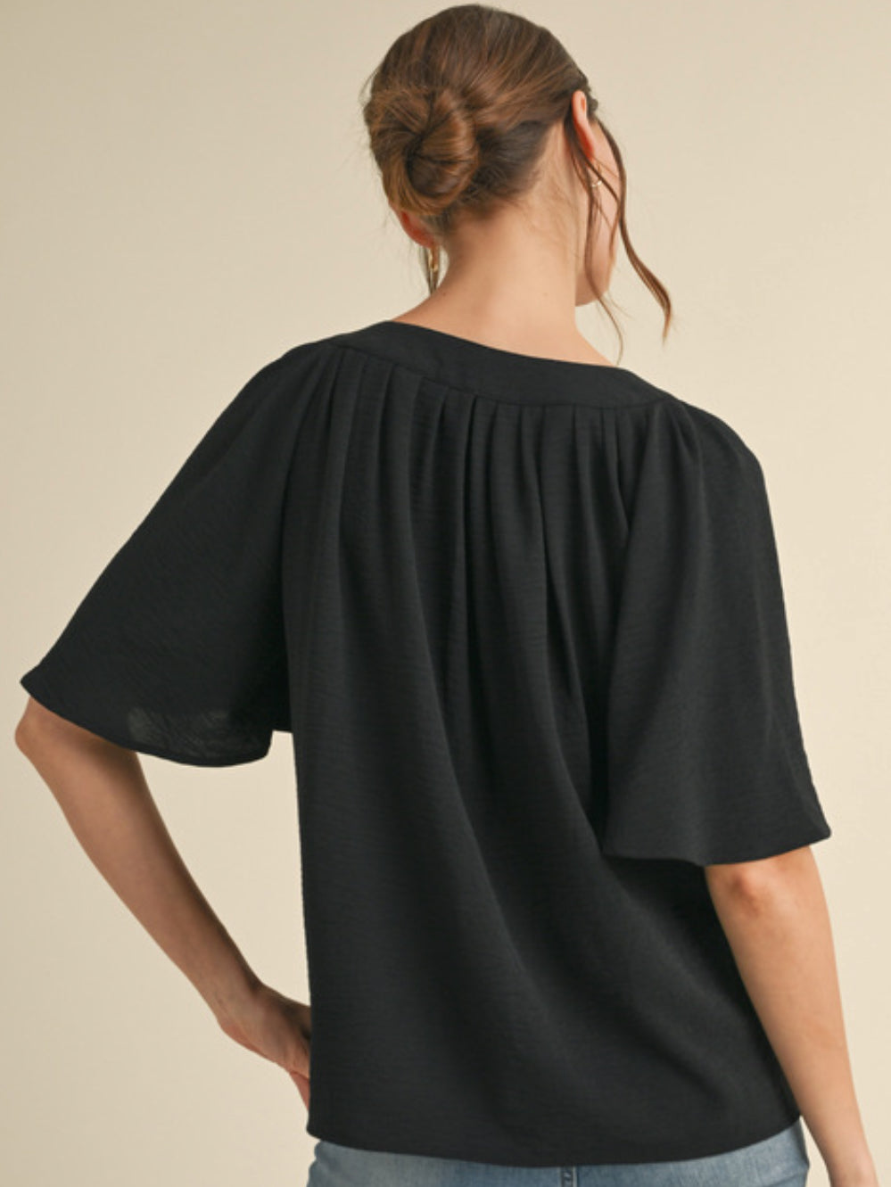 Black notch neck top with puff sleeves in lightweight airflow material