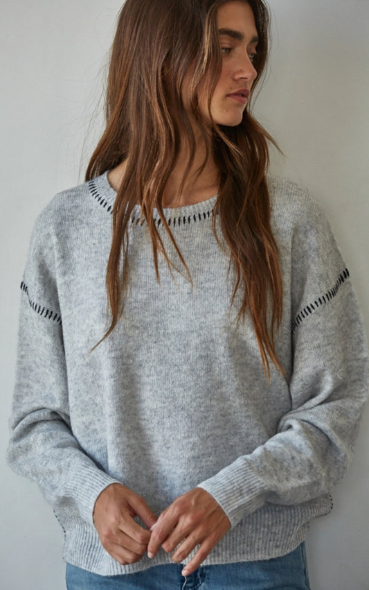 Grey soft knit top with black stitching