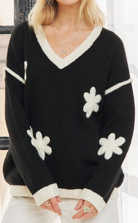 Black v neck sweater with white daisies