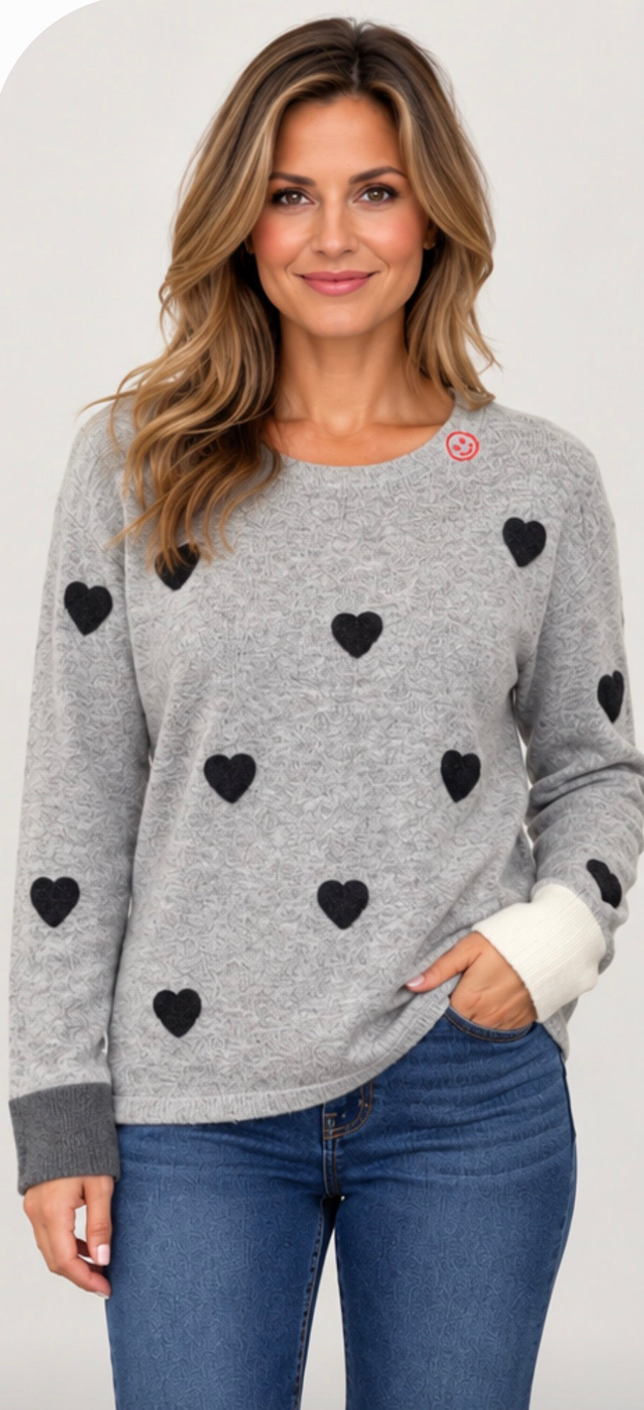Grey soft knit sweater with scattered hearts and colorblock cuffs