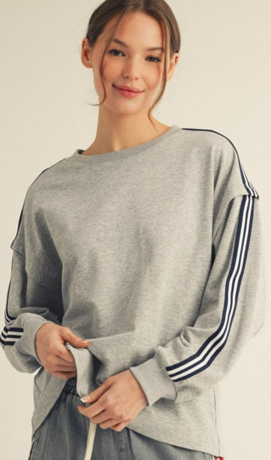 Grey sweatshirt with navy sleeve stripes