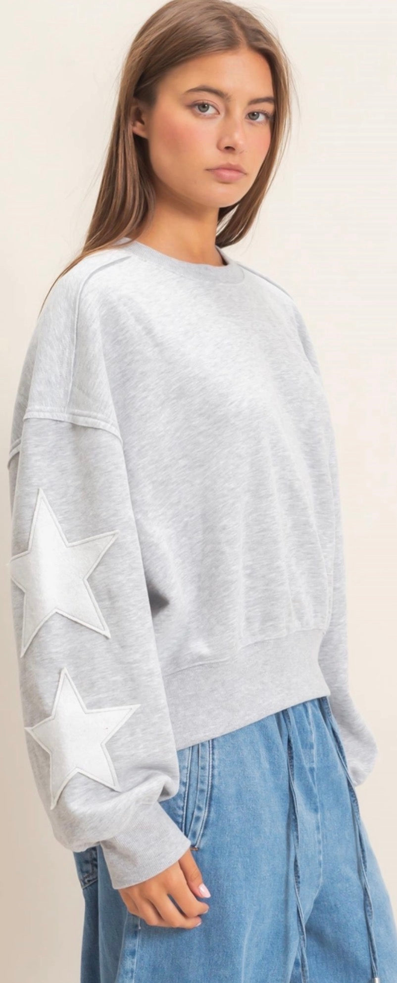 Grey sweatshirt with white stars on sleeves
