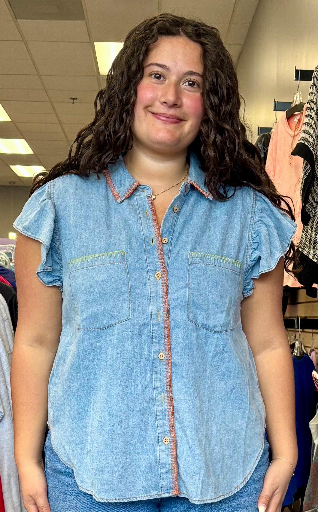 Lightweight denim ruffle shoulder blouse with multicolored stitching