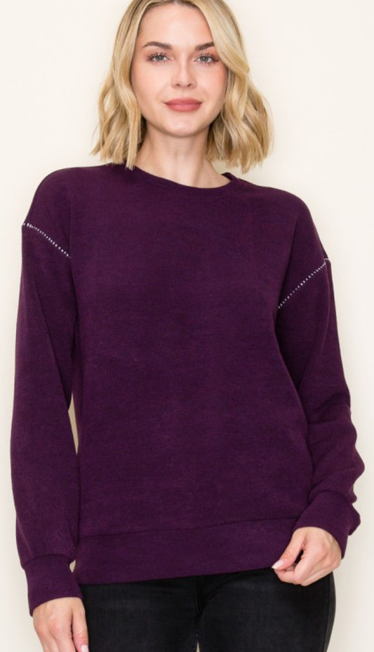 Plum textured sweater knit top with sleeve stitching