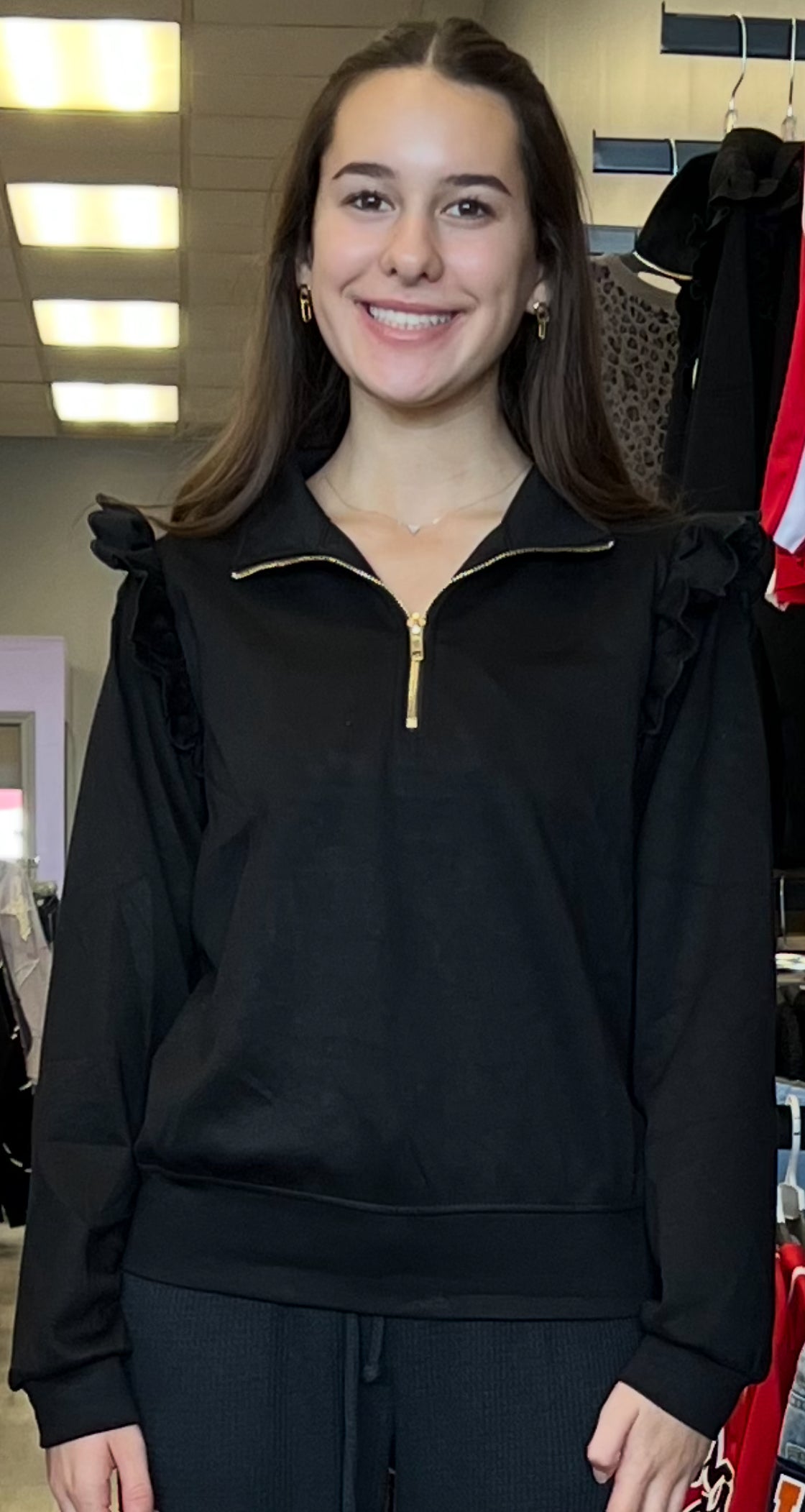 Black scuba ruffle knit quarter zip sweatshirt with gold zipper