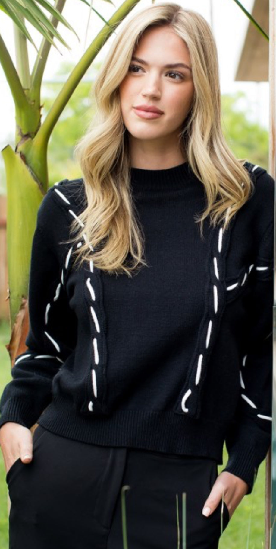 THML black sweater with white stitching