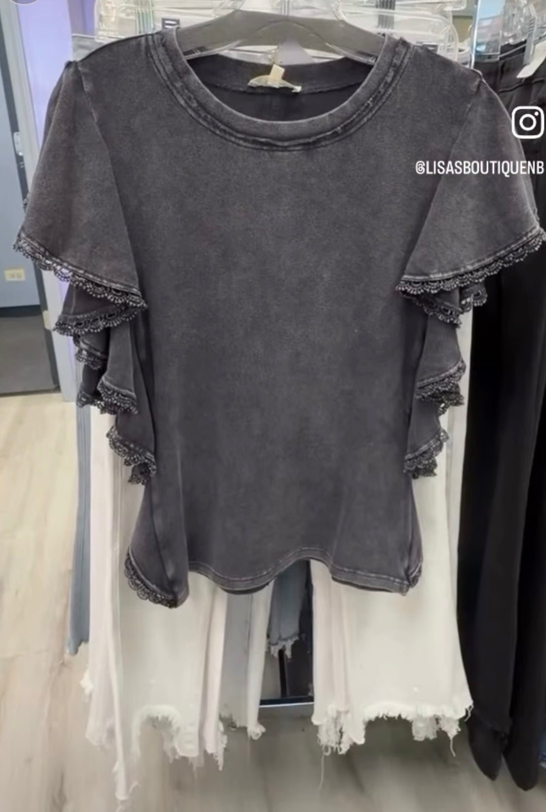 Mineral wash black ruffle sleeve top with eyelet trim
