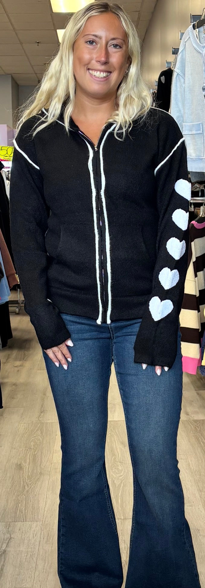 Black soft knit zip up with white hearts on one sleeve, paired with our great fitting, perfect length jeans!